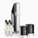 Coravin wine preservation system featuring a silver device and two black capsules, with three small gas canisters.