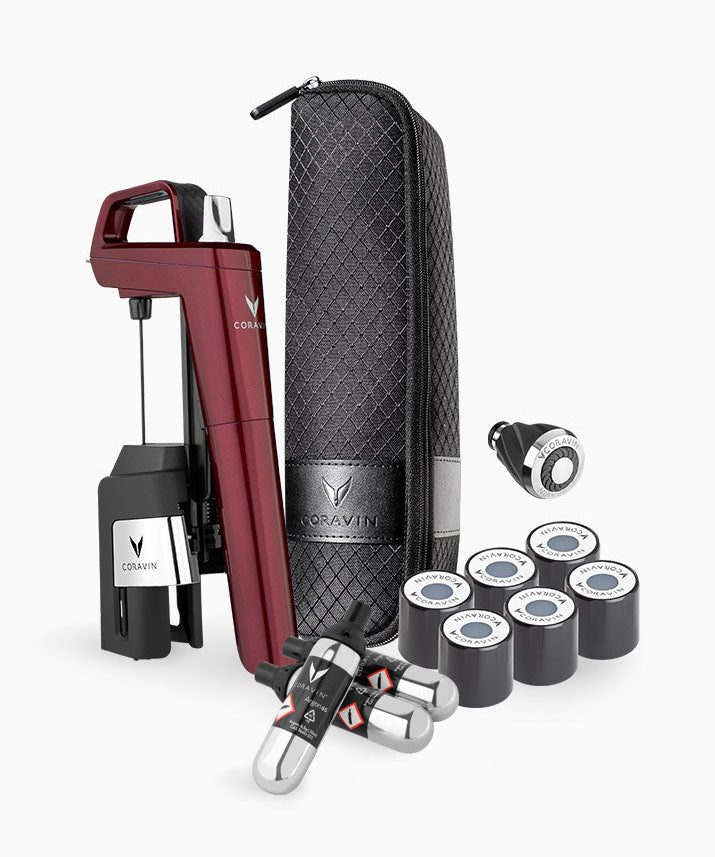 Coravin wine preservation system with a red extractor, storage case, and multiple gas canisters for wine serving.