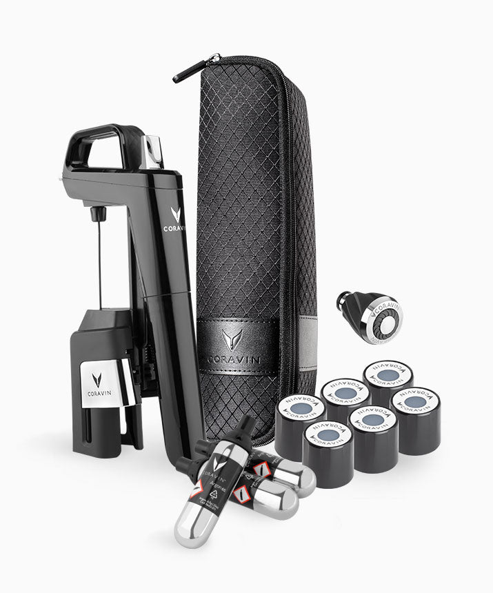 Coravin wine preservation system with black opener, carrying case, gas capsules, and pour spout.