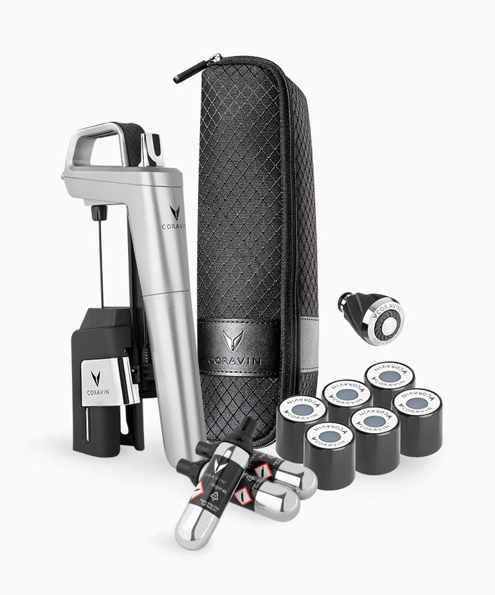 Coravin wine tool set with a silver opener, black storage case, gas cartridges, and wine preservation accessories.